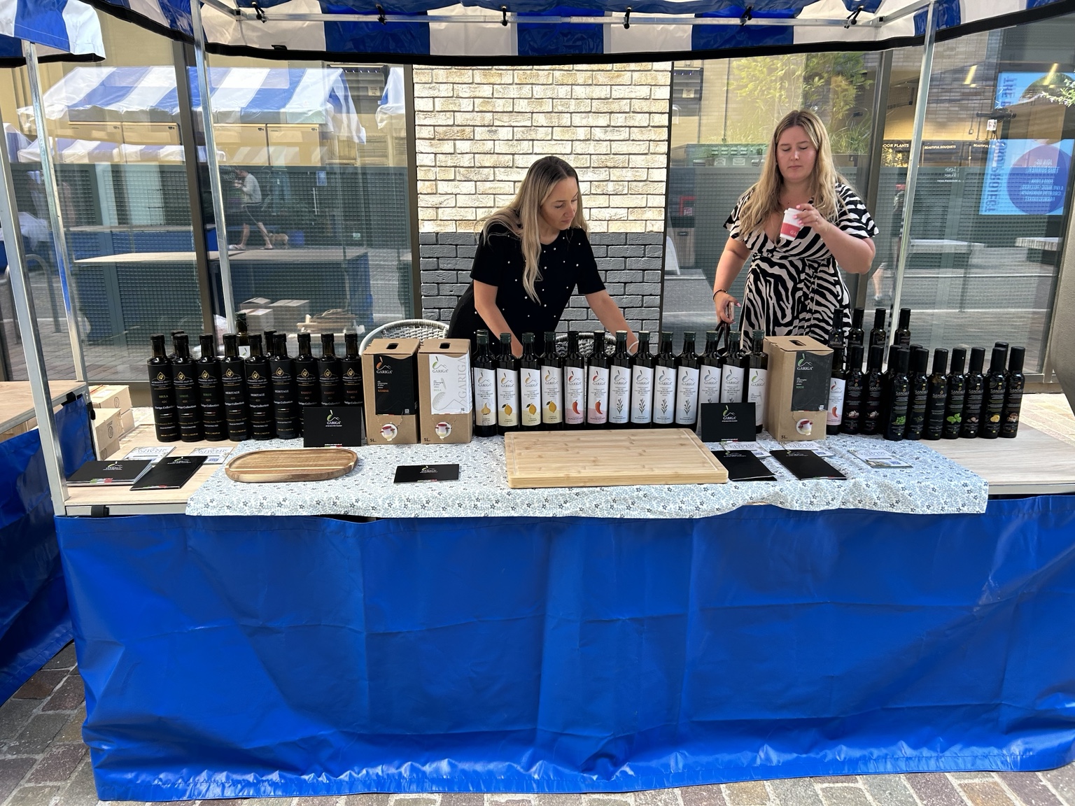 The Authentic Oliv Co stall at Brentford Farmers’ Market, displaying Gariga and Sandalia olive oils