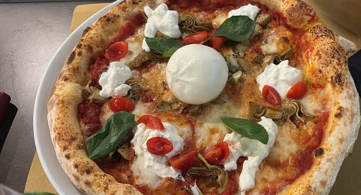 Mediterranean pizza with burrata, basil and tomato
