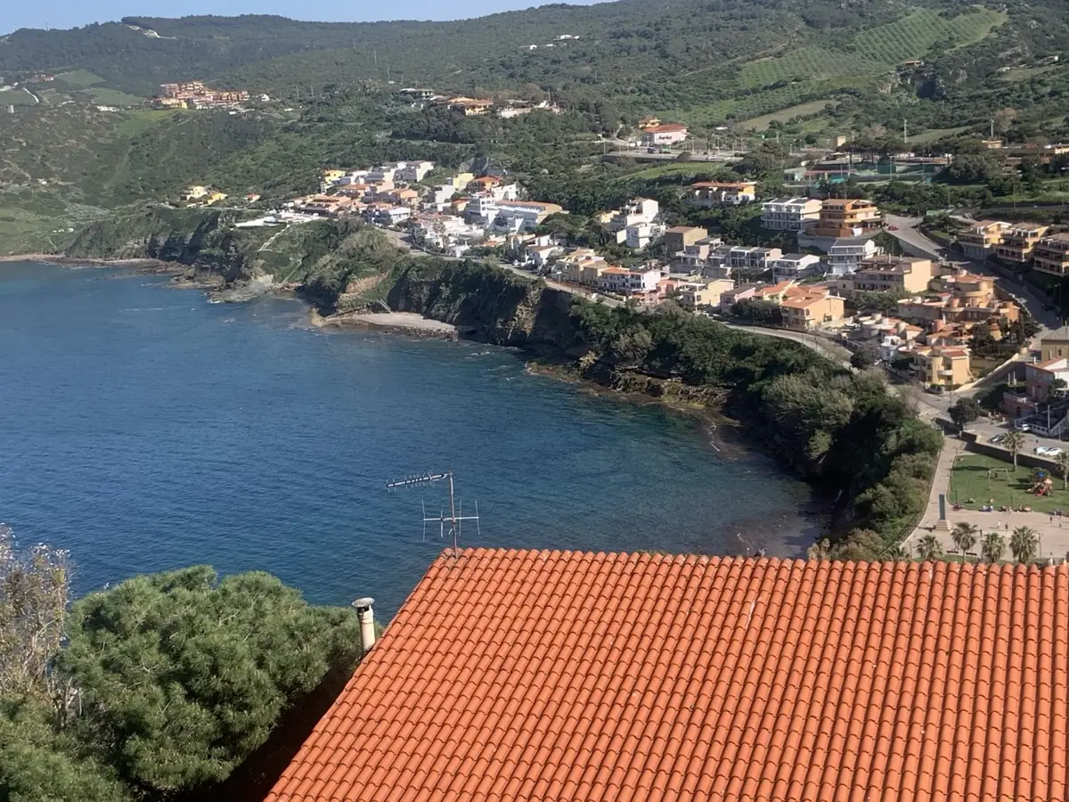 Sardinian village rooftops overlooking the blue sea